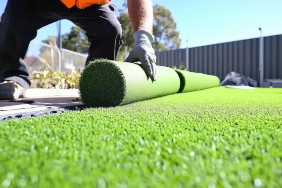Rolling out synthetic turf